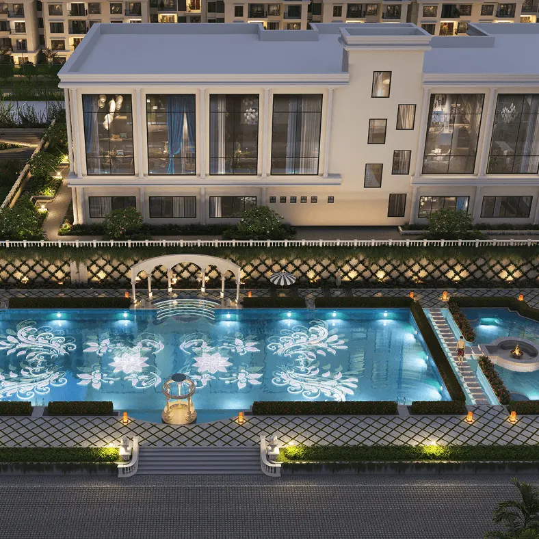 The lit swimming pool and clubhouse terrace at dusk